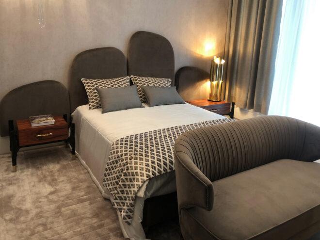 gray bedroom with sofa at the food of the bed