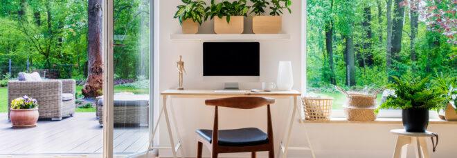 small wood desk surrounded by plants