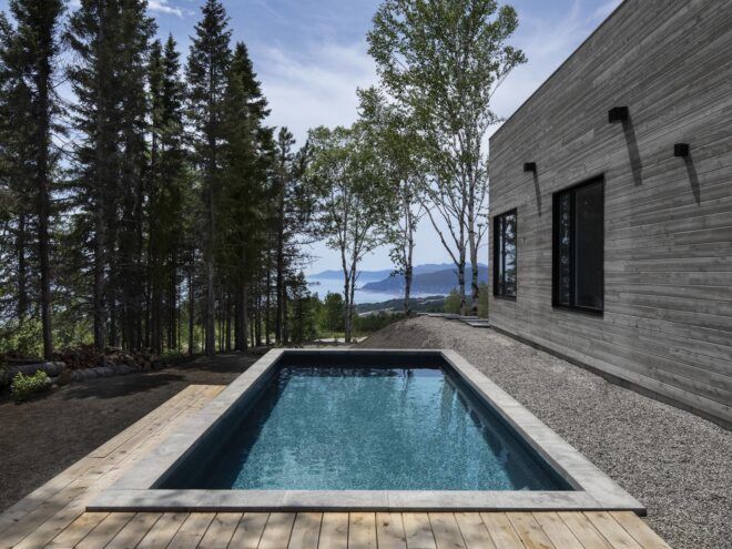 rectangular swimming pool facing ocean and mountain views