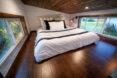 large white bed on wood loft