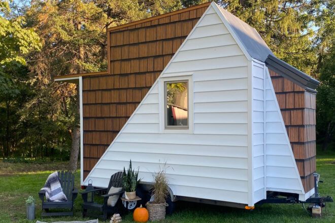 white and timber tiny home on wheels
