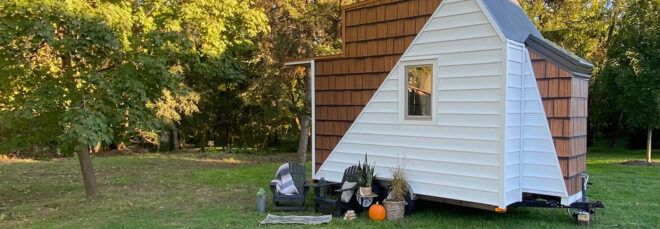 white and timber tiny home on wheels
