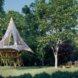 rendering of picnic table near base of a treehouse