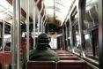 person bundled up in a coat and riding the subway