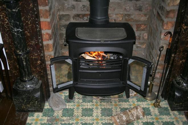 black wood-burning stove with doors open