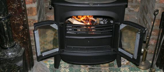 black wood-burning stove with doors open