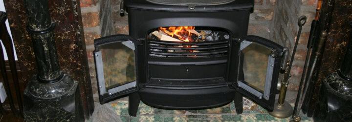 black wood-burning stove with doors open