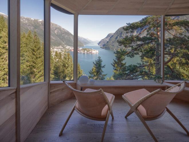 beige chairs facing a wall of glass