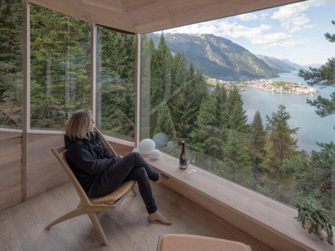 person sitting in chair looking out window