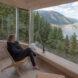 person sitting in chair looking out window