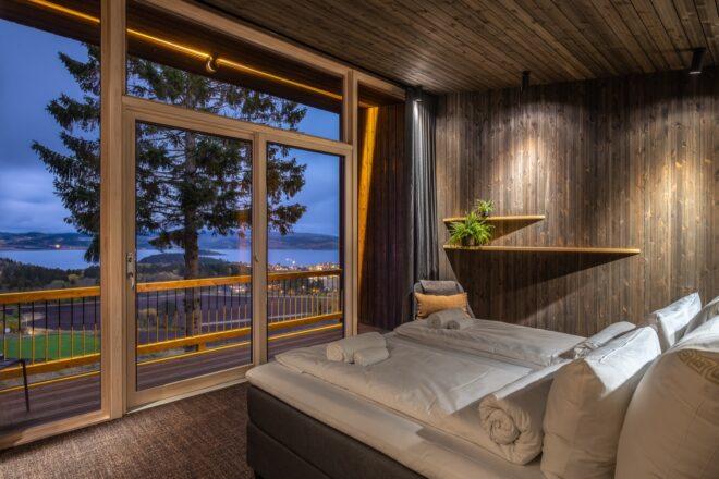 large bed facing wall of glass