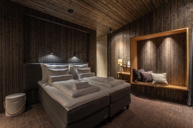 cozy hotel room with wood-paneled walls and ceiling