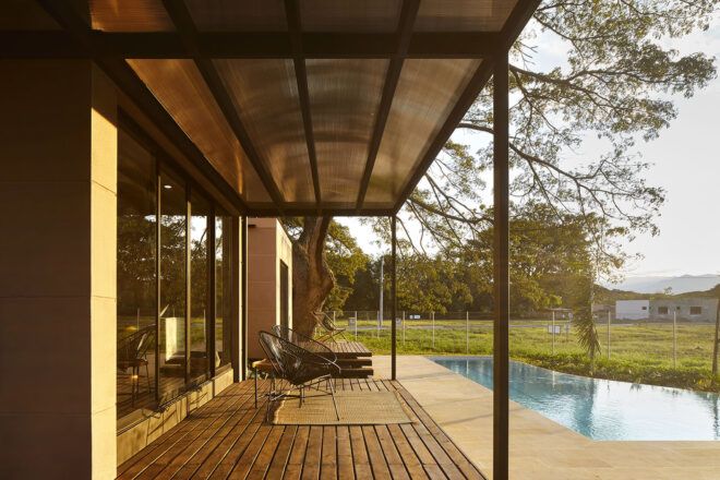 An outdoor covered deck area with chairs.