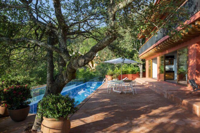 pool near a red clay home