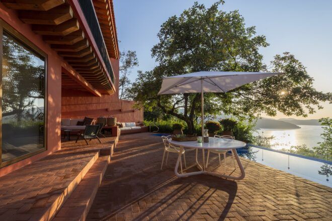 umbrella over small patio table and chairs