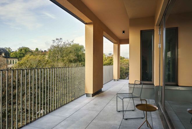A balcony with yellow-brown columns.