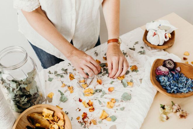 Person pressing flowers into cloth