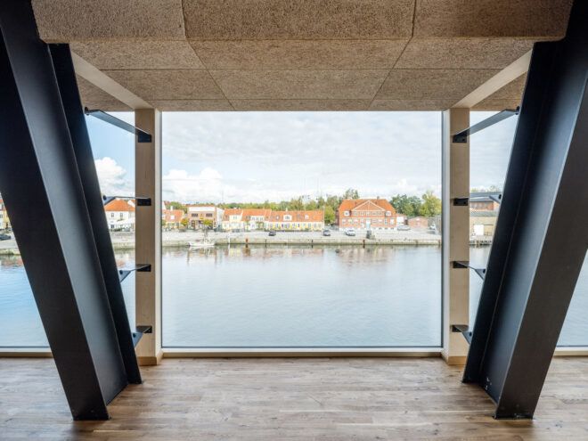 large window framing views of a harbor