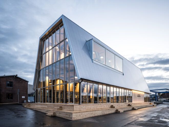 glass building with angled metal roof