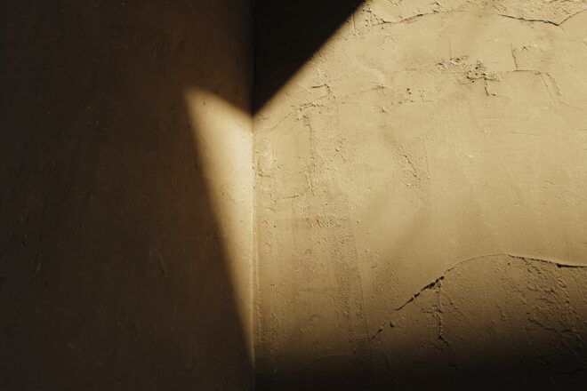 shadows casted onto raw earth walls