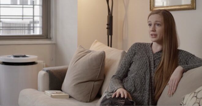 air purifier near person sitting on sofa