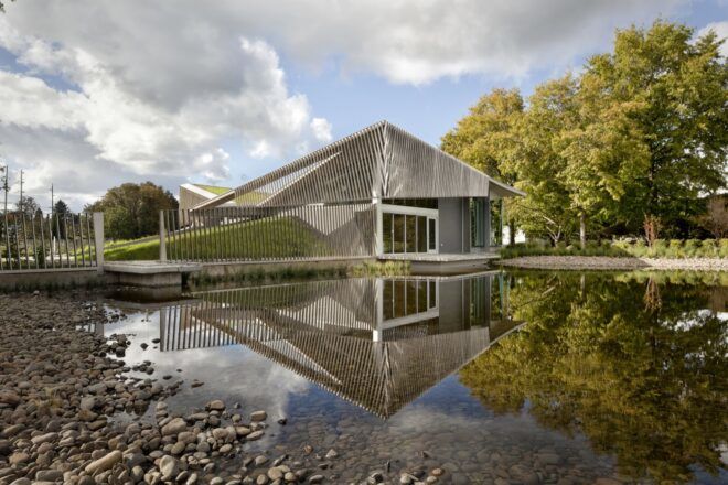 metal and concrete wastewater treatment building near water