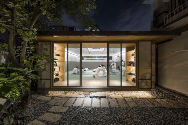 dojo glass doors opening to a courtyard at night