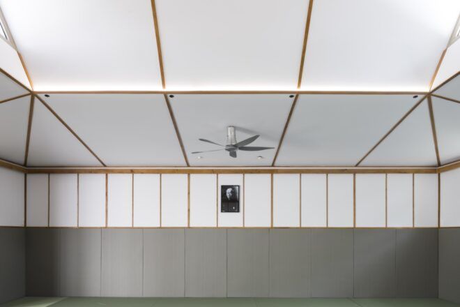fan on white ceiling with wood beams