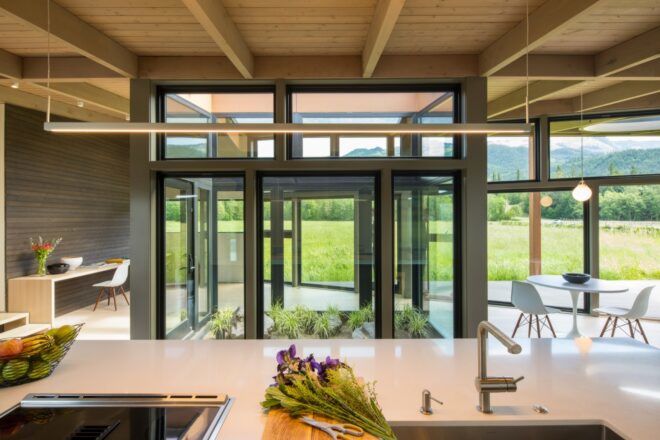 white kitchen island facing glass doors