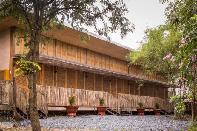 A two-story building with natural materials of bamboo and rice husk.