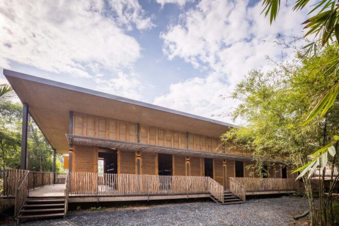 A two-story building with natural materials of bamboo and rice husk.