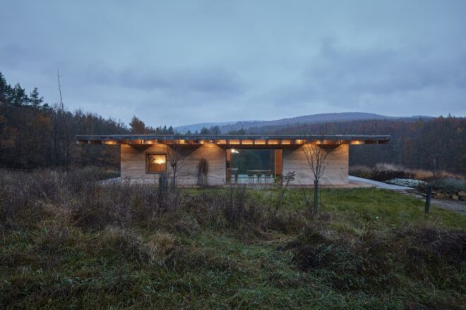 hempcrete cabin with one glass wall open to the outdoors