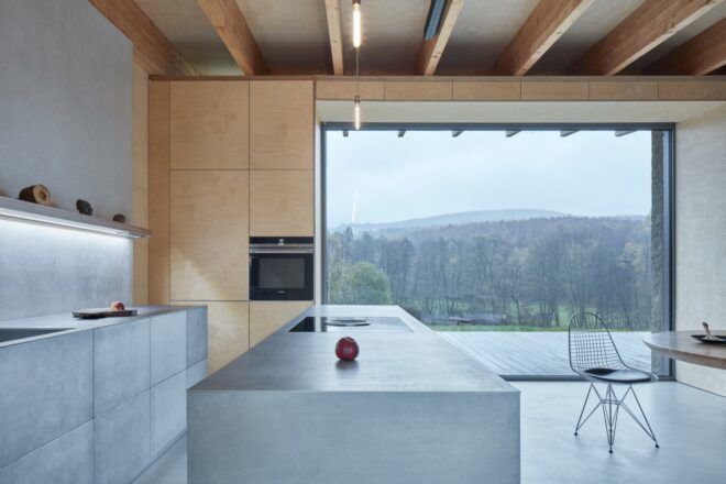 kitchen with concrete cabinets and island facing a glass wall