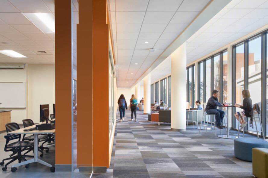 bright college building interior with gray floors and wall of windows