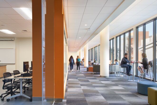 bright college building interior with gray floors and wall of windows