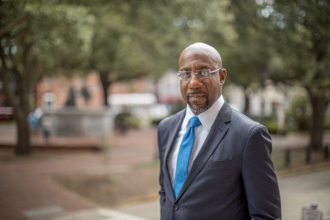 Raphael Warnock standing outside