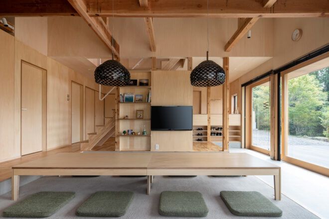 black pendant lights over long wood table
