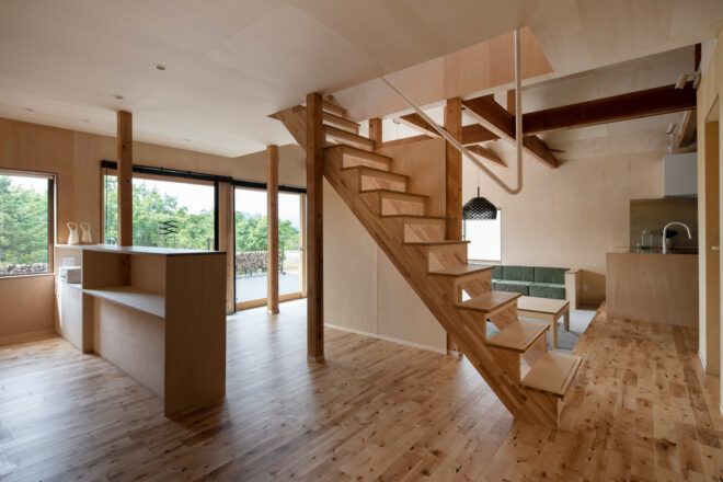 open-floor community space with wood staircase in the center