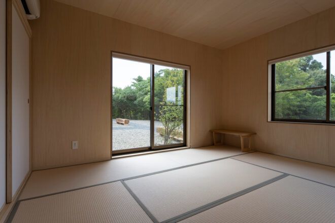 guestroom with wood walls and sliding glass doors leading to a balcony