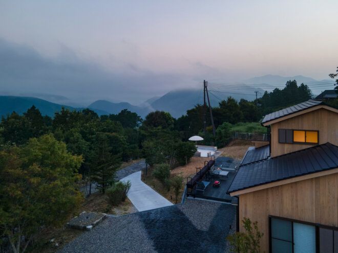 cedar building surrounded by trees and mountains