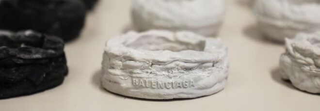 rows of black, white and gray Balenciaga bracelets