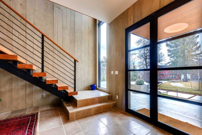 A stairwell next to two large windows.