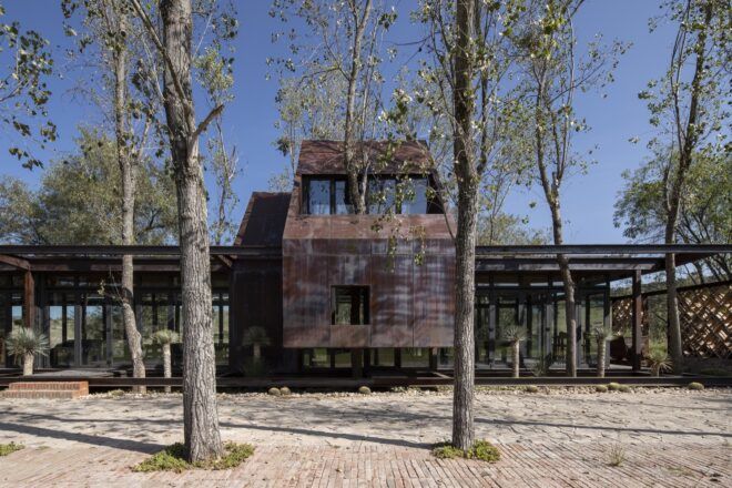 holiday home with oxidized steel and glass exterior