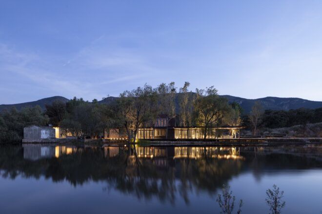 glass home next to a river