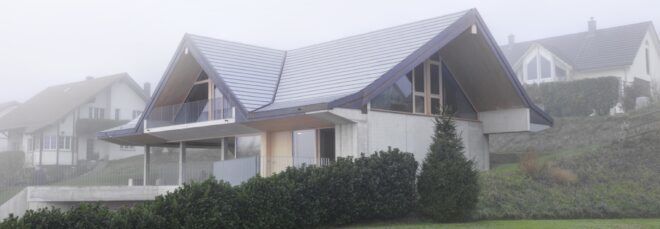 concrete and timber home on a hill
