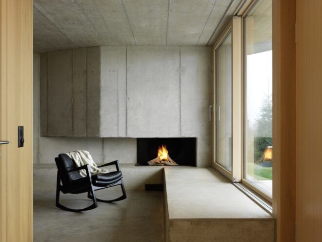 rocking chair by concrete fireplace