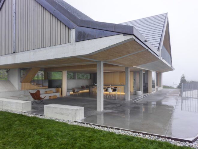 concrete and wood home with large covered patio