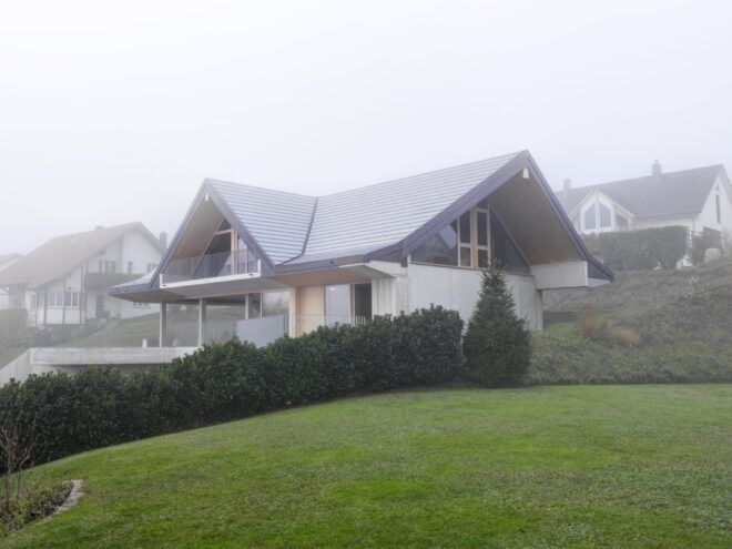 concrete and timber home on a hill