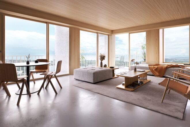 A sitting room with large windows and wood walls and ceiling. A sofa, chair and table fill the room.