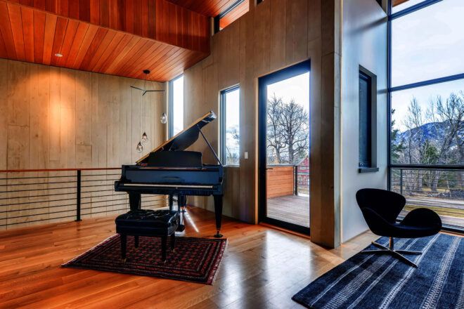 A large piano in the corner off the side of the living room.